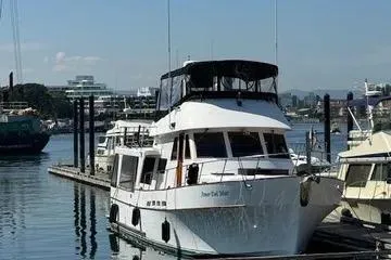 Slide: The Image of 1982 C @ L Sea Ranger yacht docked at a marina, surrounded by other boats. - 2