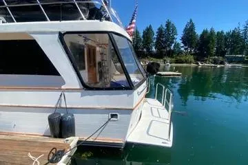 Slide: The Image of 1982 C @ L Sea Ranger yacht docked on serene water with lush trees in the background. - 23