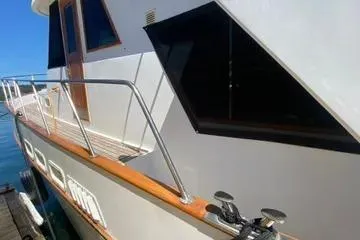 Slide: The Image of 1982 C @ L Sea Ranger boat docked, showcasing sleek design and wooden accents. - 28