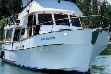 Slide: The Image of 1982 C @ L Sea Ranger yacht on tranquil water, surrounded by lush greenery. - 3