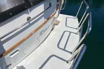 Slide: The Image of 1982 C @ L Sea Ranger boat deck with metal railings and wooden accents. - 30