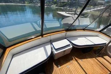 Slide: The Image of 1982 C @ L Sea Ranger boat interior with cushioned seating and wooden flooring. - 31