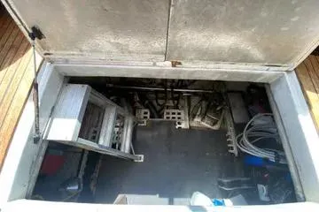 Slide: The Image of Engine compartment of a 1982 C @ L Sea Ranger boat, showing equipment and storage space. - 33