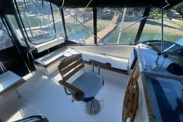 Slide: The Image of 1982 C @ L Sea Ranger boat interior with helm, seating, and panoramic windows. - 35
