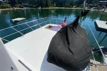 Slide: The Image of 1982 C @ L Sea Ranger boat deck with covered equipment, docked by a serene lake. - 36