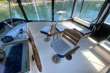 Slide: The Image of 1982 C @ L Sea Ranger boat interior with seating and helm, docked by the water. - 37