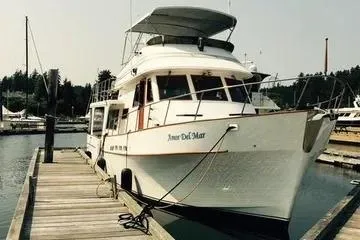 Slide: The Image of 1982 C @ L Sea Ranger yacht docked at marina, featuring classic design and spacious deck. - 4