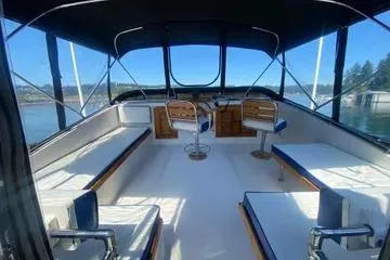 Slide: The Image of 1982 C @ L Sea Ranger boat interior with seating and helm, under a canopy. - 43