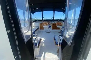 Slide: The Image of 1982 C @ L Sea Ranger interior with seating and helm, featuring clear windows and blue accents. - 44