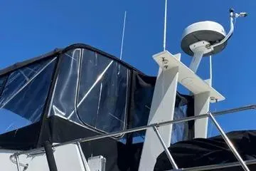 Slide: The Image of 1982 C @ L Sea Ranger boat with radar and canopy against clear blue sky. - 46