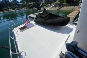 Slide: The Image of 1982 C @ L Sea Ranger boat deck with covered equipment and American flag. - 48