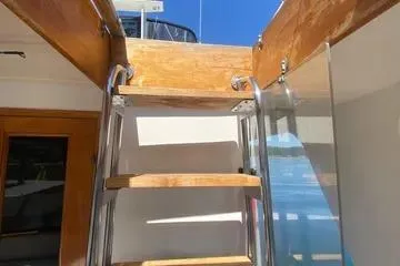Slide: The Image of Wooden ladder on 1982 C @ L Sea Ranger yacht under clear blue sky. - 49