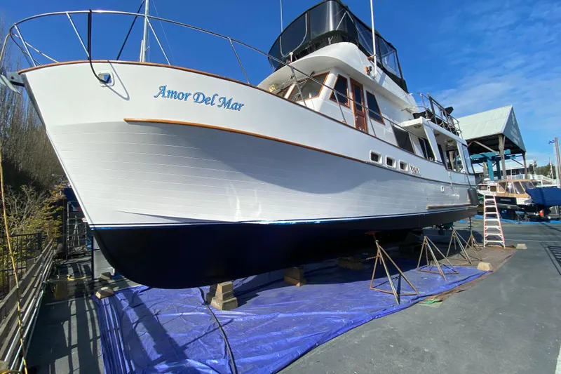 Slide: The Image of 1982 C & L Sea Ranger yacht "Amor Del Mar" on dry dock under clear blue sky. - 5