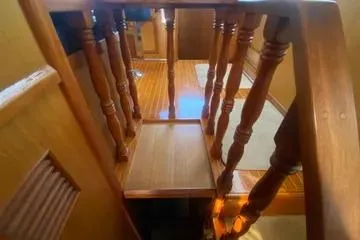 Slide: The Image of Wooden staircase inside 1982 C @ L Sea Ranger boat, showcasing polished railings and steps. - 52