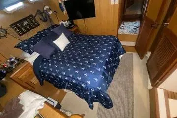 Slide: The Image of Cozy bedroom interior of 1982 C @ L Sea Ranger yacht with nautical-themed bedding. - 56