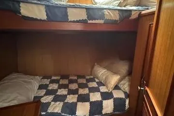 Slide: The Image of Cozy bunk beds in 1982 C @ L Sea Ranger yacht cabin with checkered bedding. - 58