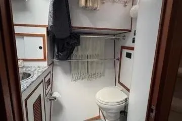 Slide: The Image of 1982 C @ L Sea Ranger bathroom with toilet, sink, and towel rack. - 59