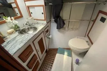Slide: The Image of 1982 C @ L Sea Ranger bathroom with sink, toilet, and storage cabinets. - 60