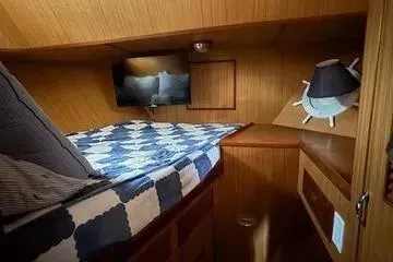 Slide: The Image of Cozy cabin interior of 1982 C @ L Sea Ranger with nautical decor and bedding. - 62
