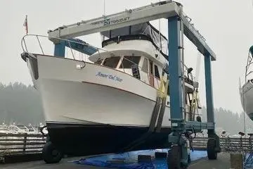 Slide: The Image of 1982 C @ L Sea Ranger boat on lift at marina, ready for maintenance. - 7