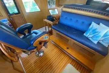 Slide: The Image of 1982 C @ L Sea Ranger interior with blue seating and wooden flooring. - 71