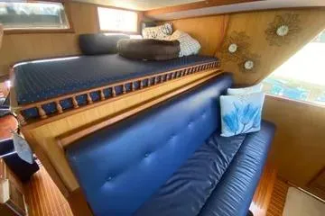 Slide: The Image of Interior of 1982 C @ L Sea Ranger boat with blue seating and wooden accents. - 72