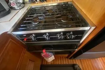 Slide: The Image of 1982 C @ L Sea Ranger stove with four burners in a wooden kitchen setting. - 73