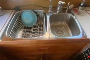 Slide: The Image of 1982 C @ L Sea Ranger kitchen sink with dish rack and faucet. - 74