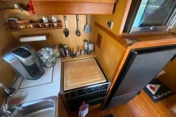 Slide: The Image of 1982 C @ L Sea Ranger kitchen with appliances and wooden cabinetry. - 78