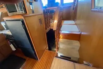 Slide: The Image of 1982 C @ L Sea Ranger interior with wooden stairs and kitchen area. - 79