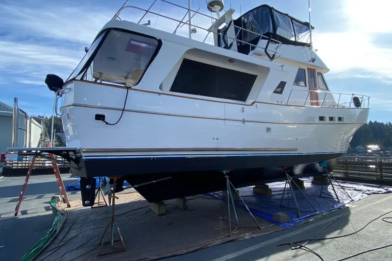 Slide: The Image of 1982 C & L Sea Ranger yacht on dry dock, undergoing maintenance under clear blue sky. - 8
