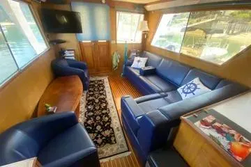 Slide: The Image of 1982 C @ L Sea Ranger interior with blue seating, nautical decor, and large windows. - 84