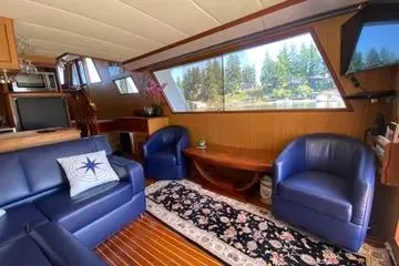 Slide: The Image of Luxurious 1982 C @ L Sea Ranger yacht interior with blue seating, large windows, and elegant decor. - 87