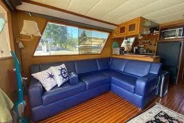 Slide: The Image of Interior of 1982 C @ L Sea Ranger with blue seating and wooden accents. - 89