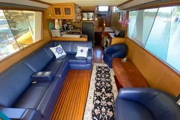 Slide: The Image of Interior of 1982 C @ L Sea Ranger yacht with blue seating and wooden flooring. - 90
