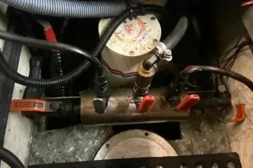 Slide: The Image of Engine compartment of 1982 C @ L Sea Ranger boat with visible wiring and components. - 95