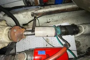 Slide: The Image of Engine compartment of a 1982 C @ L Sea Ranger boat, showing mechanical components and hoses. - 97