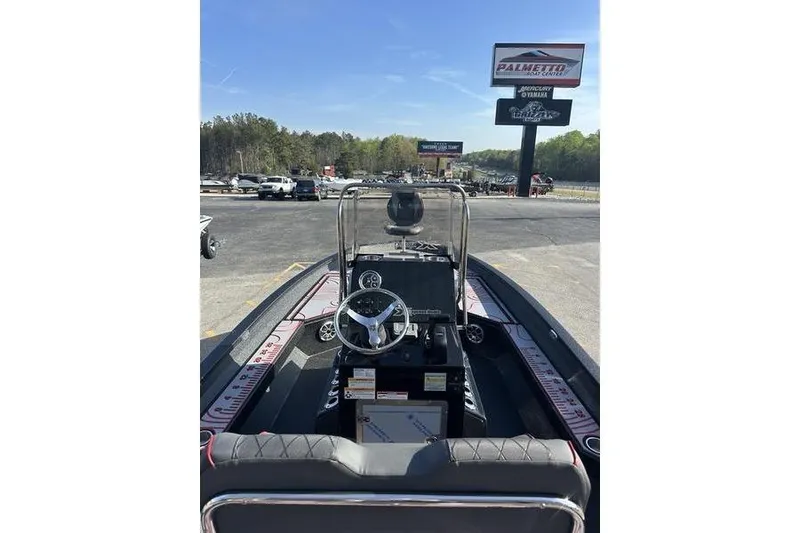 Slide: The Image of 2026 Xpress H22B Bay boat interior with steering wheel, parked at dealership. - 11