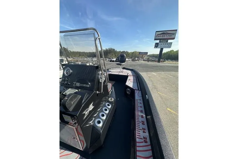 Slide: The Image of 2026 Xpress H22B Bay boat interior with console and measuring ruler on deck. - 12