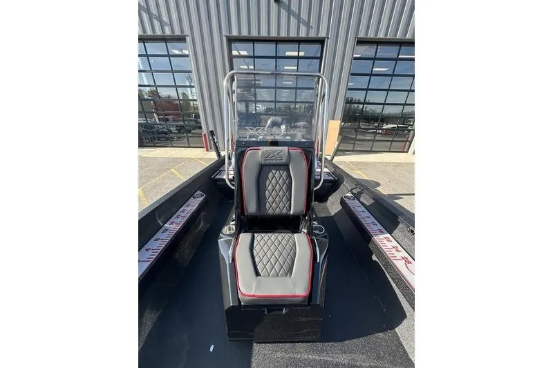 Slide: The Image of 2026 Xpress H22B Bay boat interior with diamond-stitched seating and measuring ruler. - 3