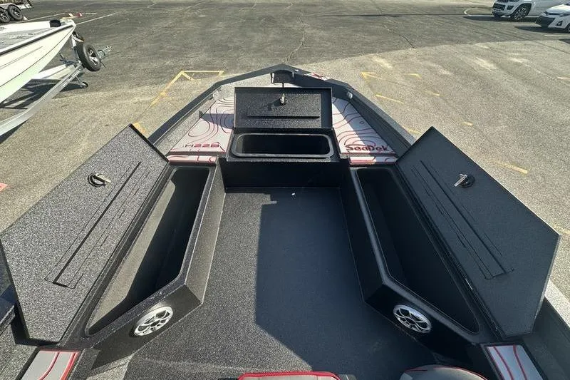 Slide: The Image of 2026 Xpress H22B Bay boat interior with open storage compartments and speakers. - 9