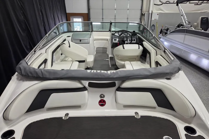 Slide: The Image of 2015 Yamaha Boats SX190 interior view, showcasing seating and steering area in a showroom. - 5