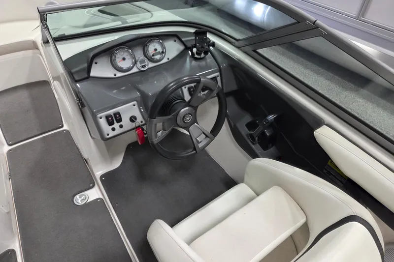 Slide: The Image of 2015 Yamaha Boats SX190 cockpit with steering wheel and dashboard controls. - 8