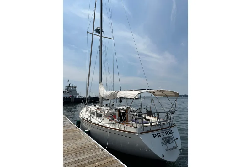 The Image of 1984 Sabre 38 sailboat docked at a marina under a clear sky. - 0