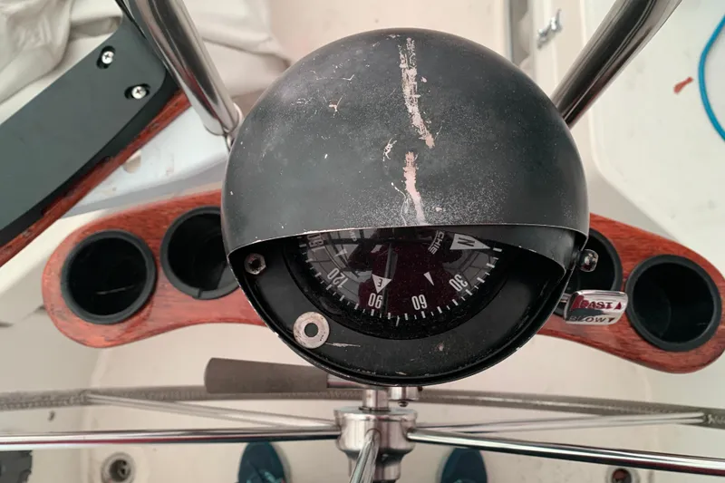 Slide: The Image of 1984 Sabre 38 sailboat compass and helm with wooden cup holders. - 16