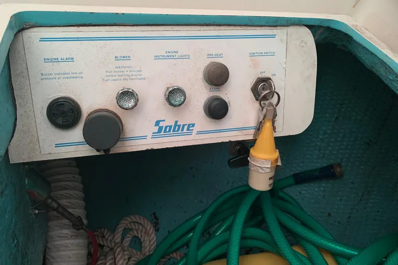 Slide: The Image of Control panel of a 1984 Sabre 38 boat with ignition switch and engine controls. - 28