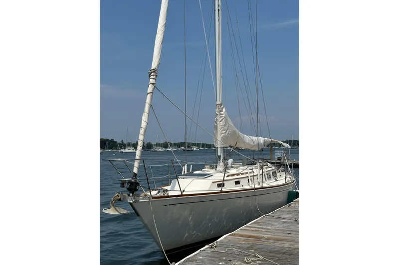 Slide: The Image of 1984 Sabre 38 sailboat docked by the water on a sunny day. - 3
