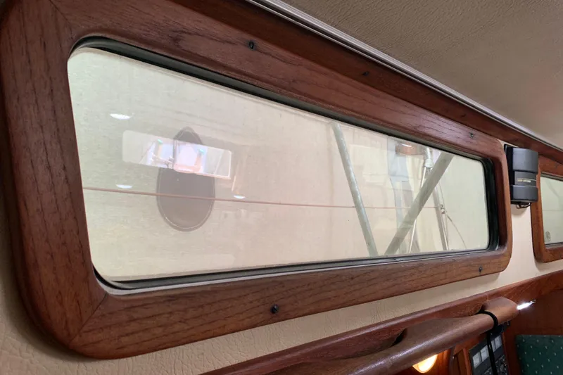 Slide: The Image of Interior view of a 1984 Sabre 38 sailboat, featuring wooden-framed windows. - 37