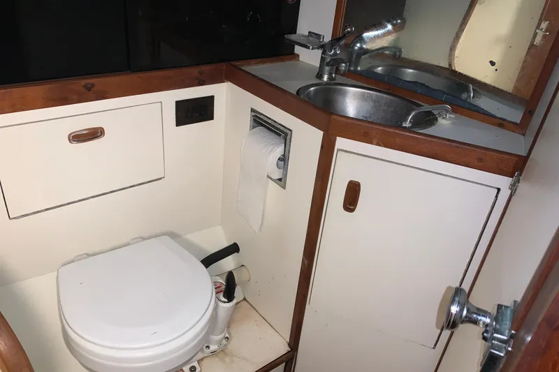 Slide: The Image of Compact bathroom in a 1984 Sabre 38 sailboat with toilet and sink. - 41