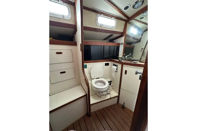 Slide: The Image of 1984 Sabre 38 yacht bathroom with wooden accents and compact design. - 42